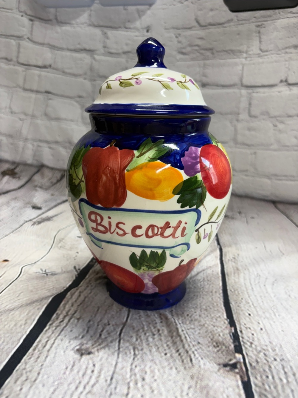 Blue-Trimmed Hand-Painted Ceramic Jar with Red Fruit Motif